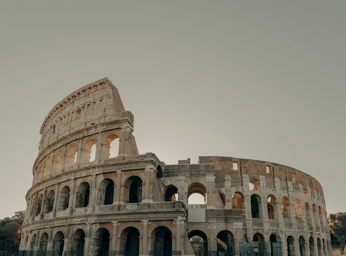 The ancient Colosseum in Rome, Italy under a clear sky