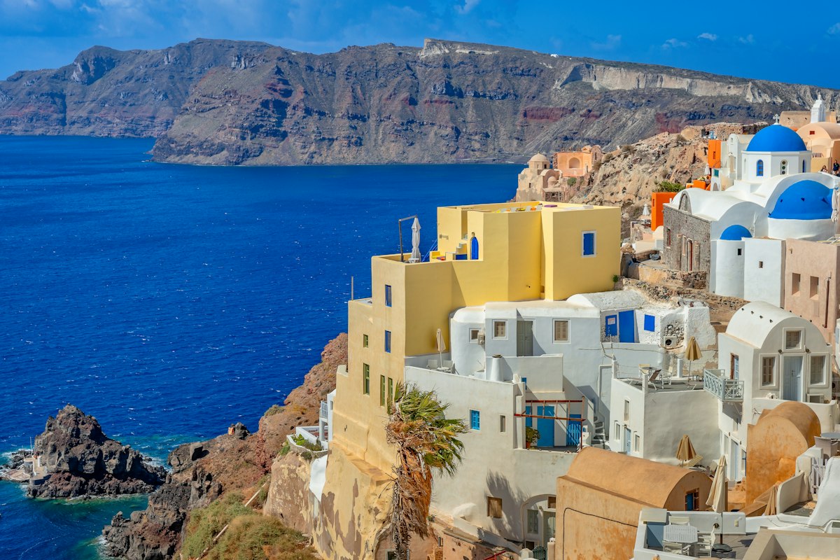 Whitewashed buildings with blue domes overlooking the sea in Santorini, Greece
